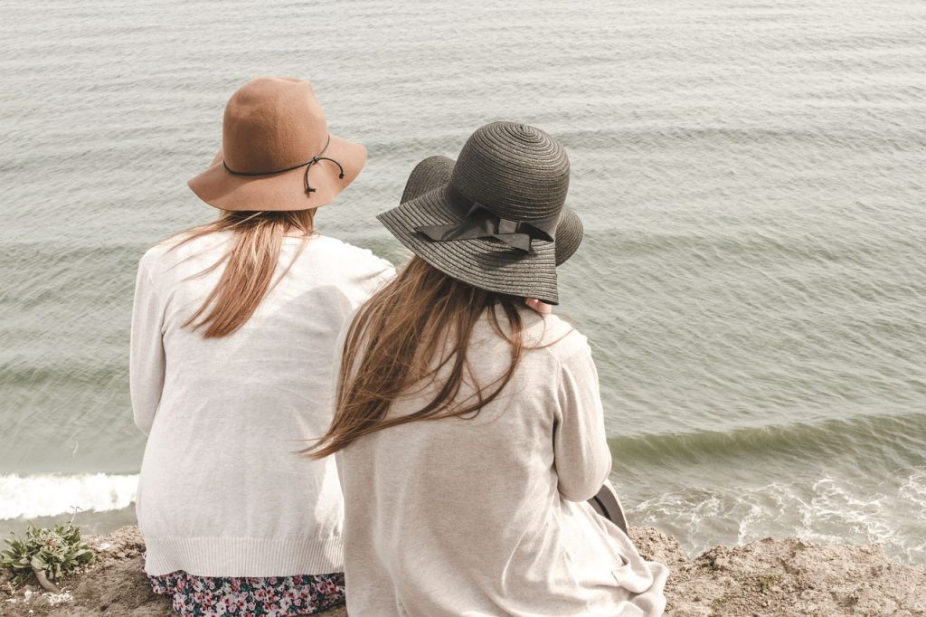 Two girls sitting on a beach